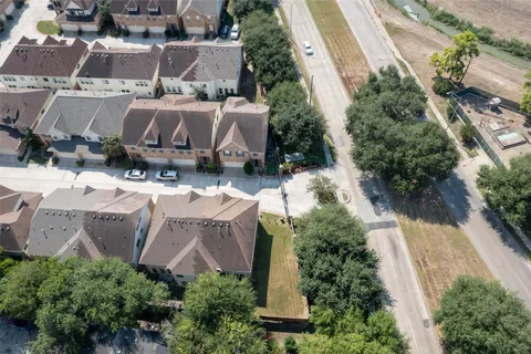an aerial view of a house with a yard and lake view