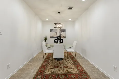 a dining room with a table and chairs