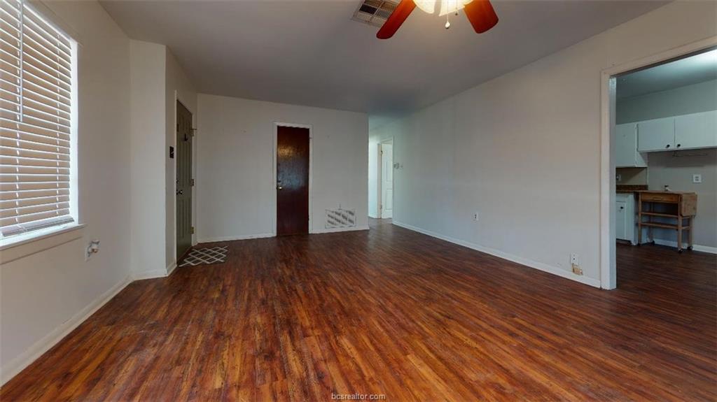 Unfurnished living room with ceiling fan, visible