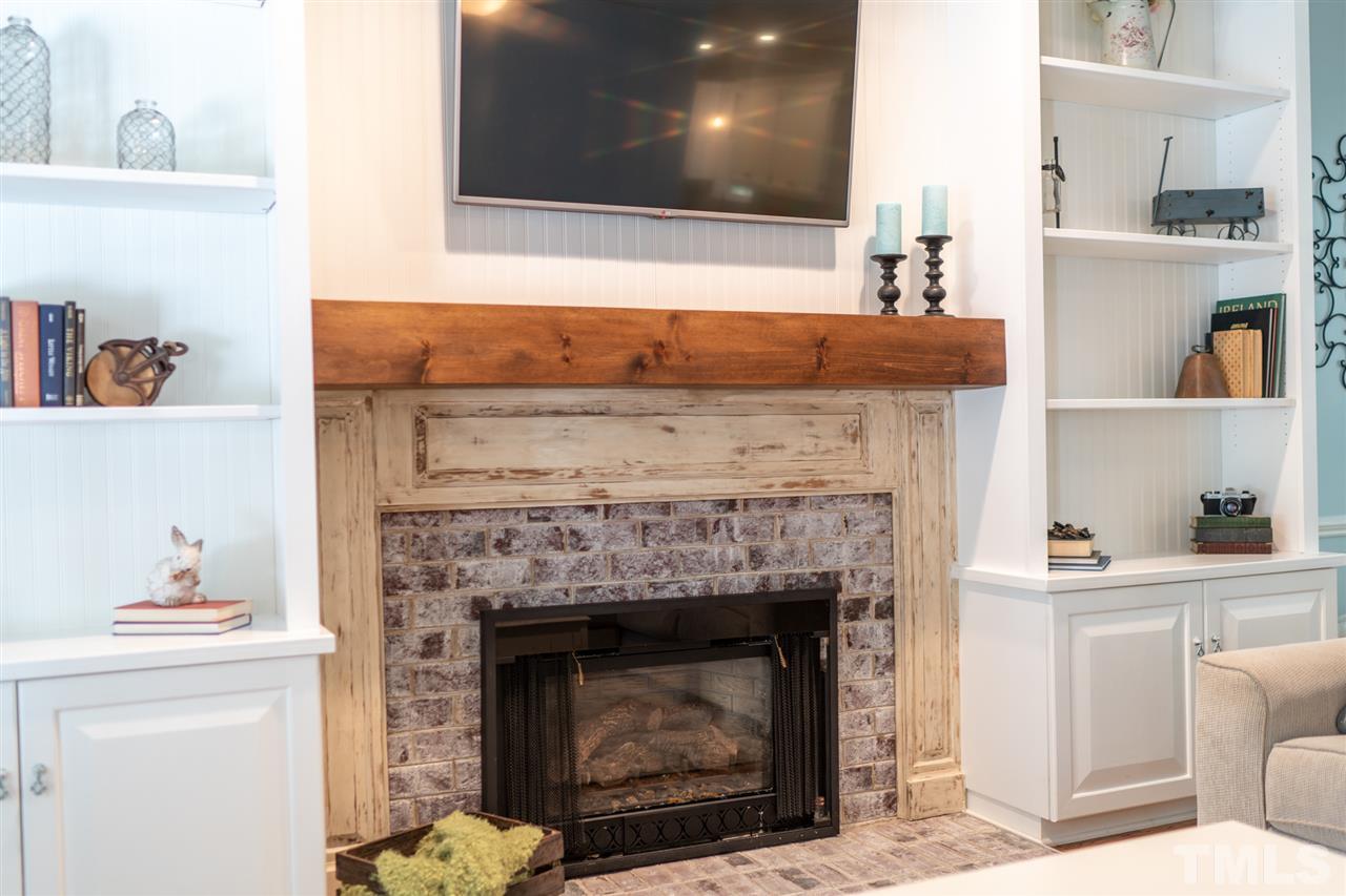 2101 Fountain Ridge Road Chapel Hill, NC 27517 - Photo 4 of 30 a living room with a fireplace and a wooden floor
