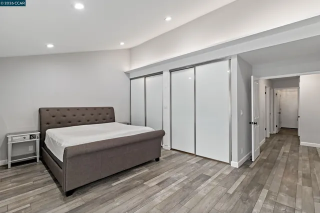 a spacious bedroom with a bed and a table