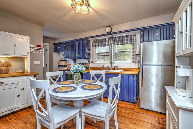 a kitchen with stainless steel appliances granite countertop a sink stove and wooden floor