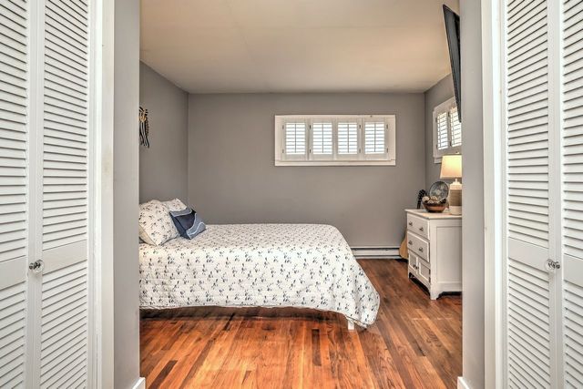 a bedroom with a bed and a television