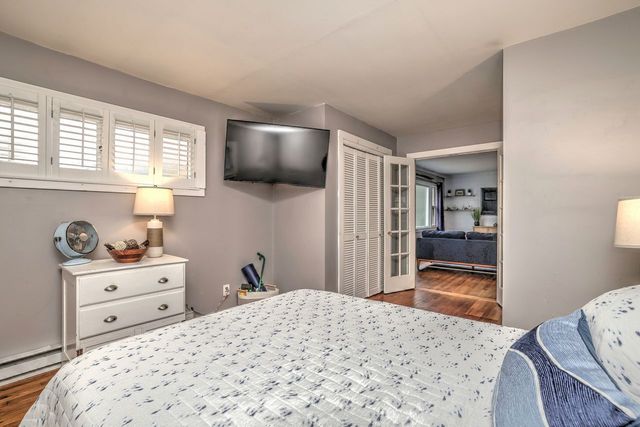 a view of livingroom with hardwood floor and a hallway