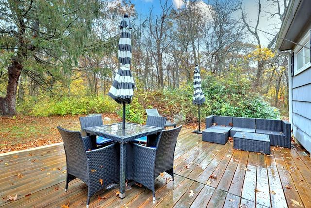 a backyard of a house with table and chairs