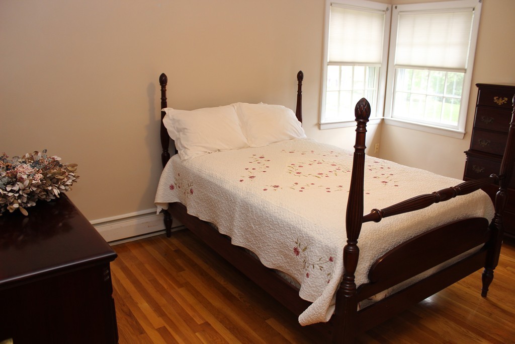 2 Ridge Road Hudson, MA 01749 - Photo 13 of 25 a bed sitting in a bedroom next to a window