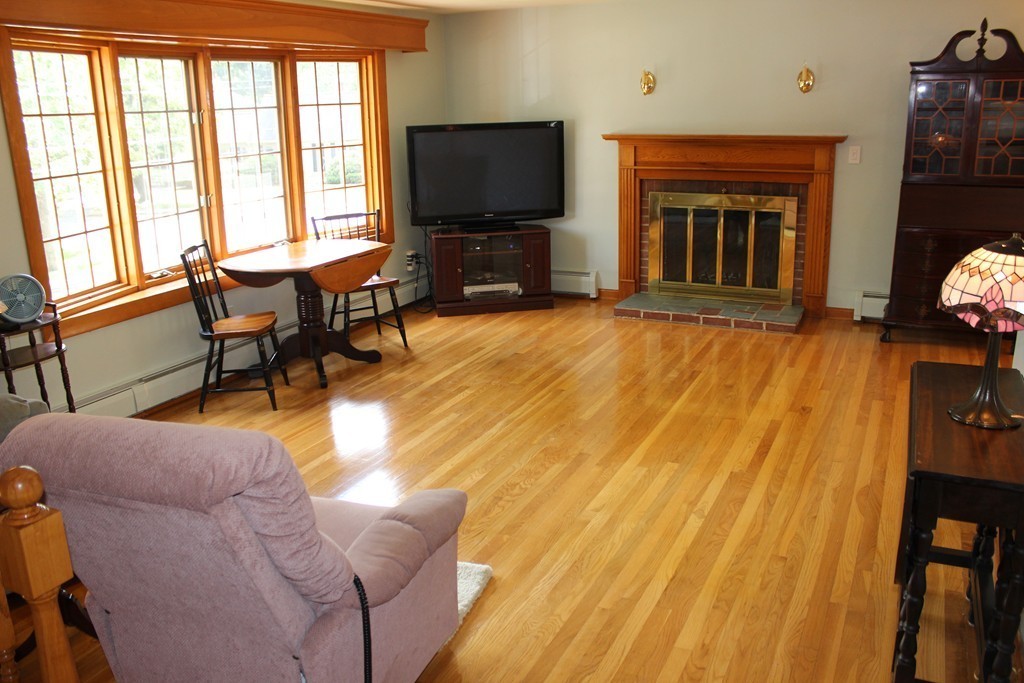 2 Ridge Road Hudson, MA 01749 - Photo 3 of 25 a living room with furniture a flat screen tv and a fireplace