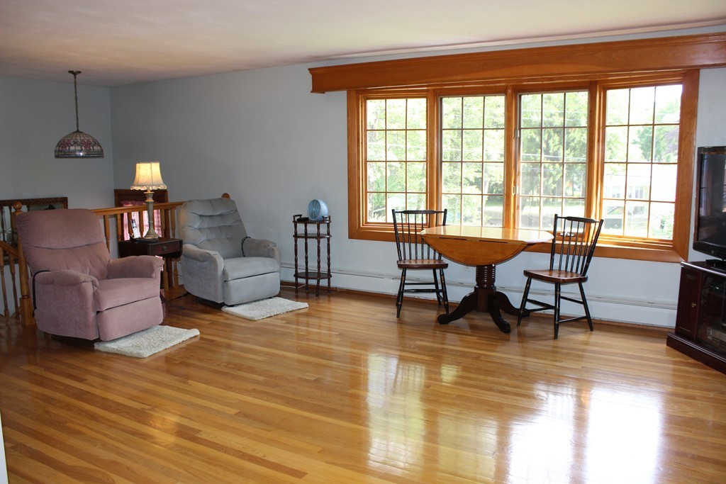 2 Ridge Road Hudson, MA 01749 - Photo 4 of 25 a living room with couches and a dining table with wooden floor