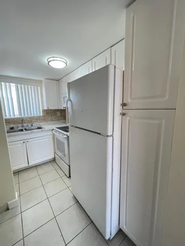 a kitchen with a cabinets a sink and a stainless steel appliances