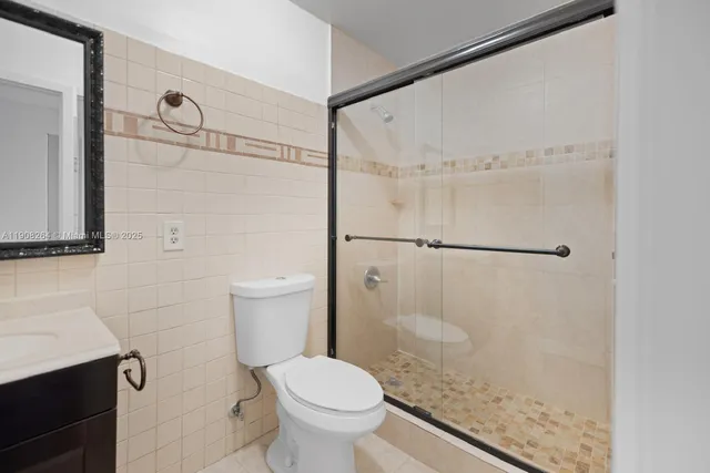 a bathroom with a shower a toilet and a sink