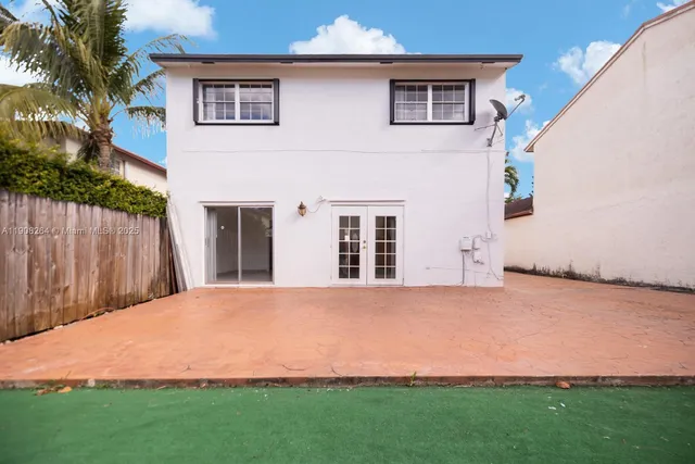 a view of an house with backyard space and balcony