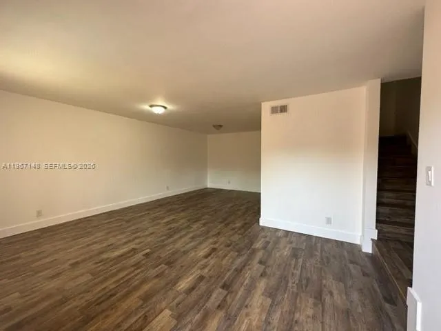 an empty room with wooden floor