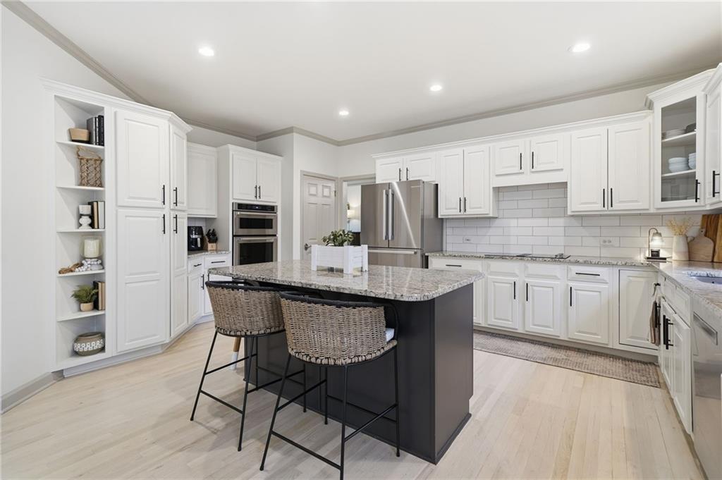 207 Cedarhurst Drive Canton, GA 30115 - Photo 15 of 83 a kitchen with kitchen island granite countertop a sink cabinets and stainless steel appliances