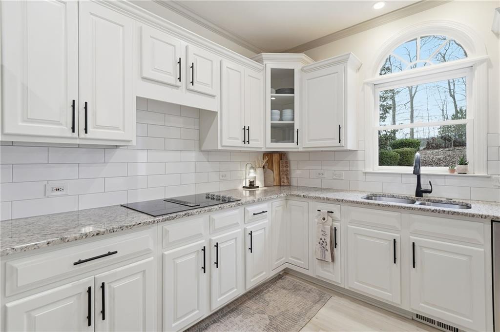 207 Cedarhurst Drive Canton, GA 30115 - Photo 18 of 83 a kitchen with white cabinets white appliances and sink
