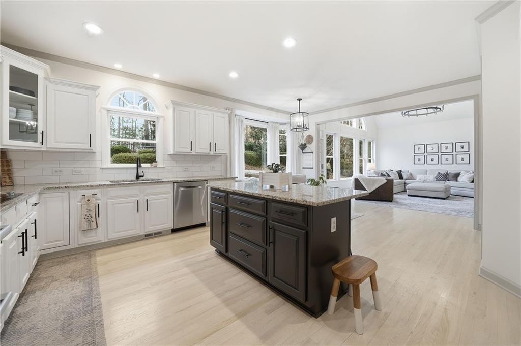 207 Cedarhurst Drive Canton, GA 30115 - Photo 19 of 83 a large kitchen with a large counter top space a sink stainless steel appliances and cabinets