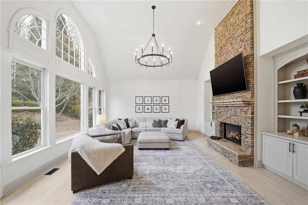 207 Cedarhurst Drive Canton, GA 30115 - Photo 20 of 83 a living room with furniture a fireplace and a flat screen tv