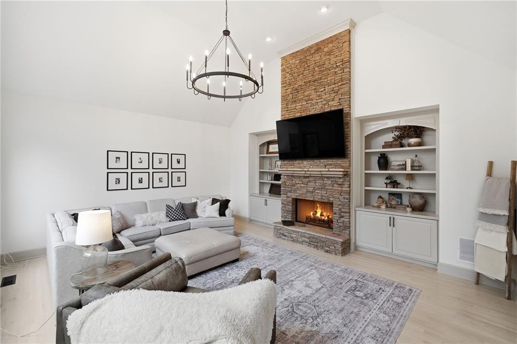 207 Cedarhurst Drive Canton, GA 30115 - Photo 21 of 83 a living room with furniture a fireplace and a flat screen tv