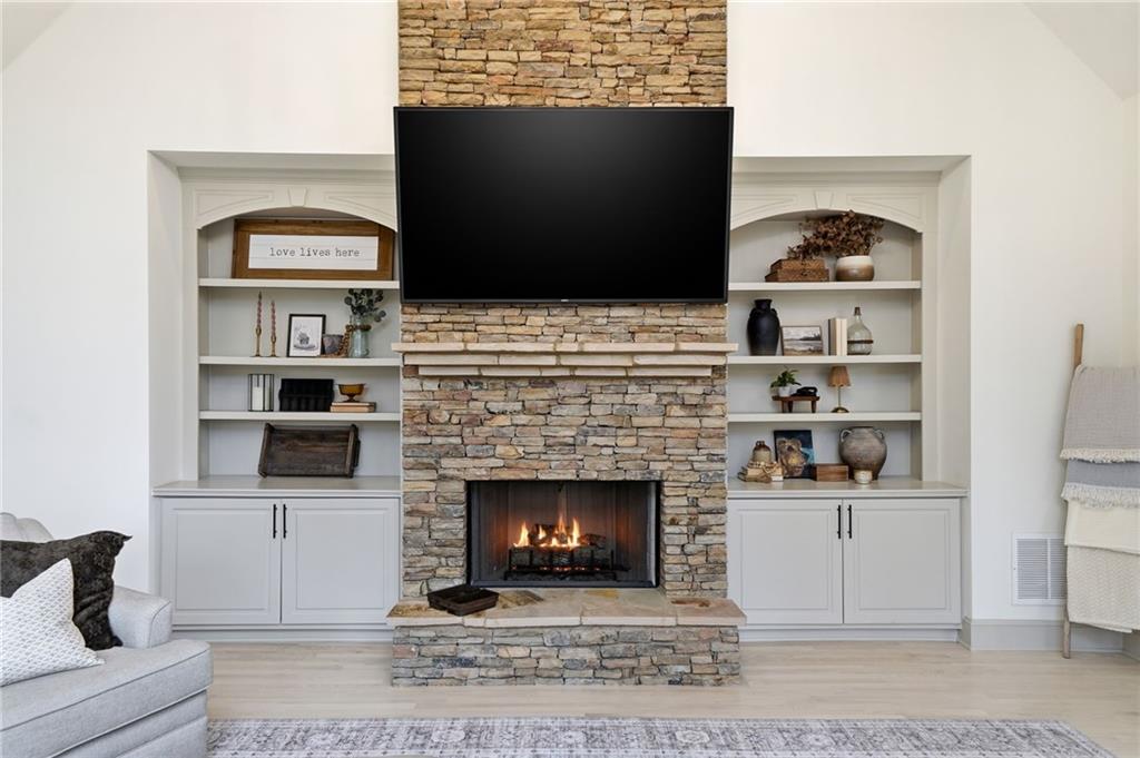 207 Cedarhurst Drive Canton, GA 30115 - Photo 22 of 83 a living room with a fireplace and a flat screen tv