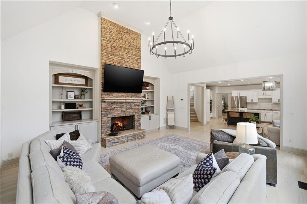 207 Cedarhurst Drive Canton, GA 30115 - Photo 25 of 83 a living room with furniture a fireplace and a flat screen tv