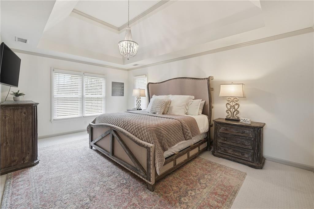 207 Cedarhurst Drive Canton, GA 30115 - Photo 30 of 83 a spacious bedroom with a bed and a flat tv screen on dresser