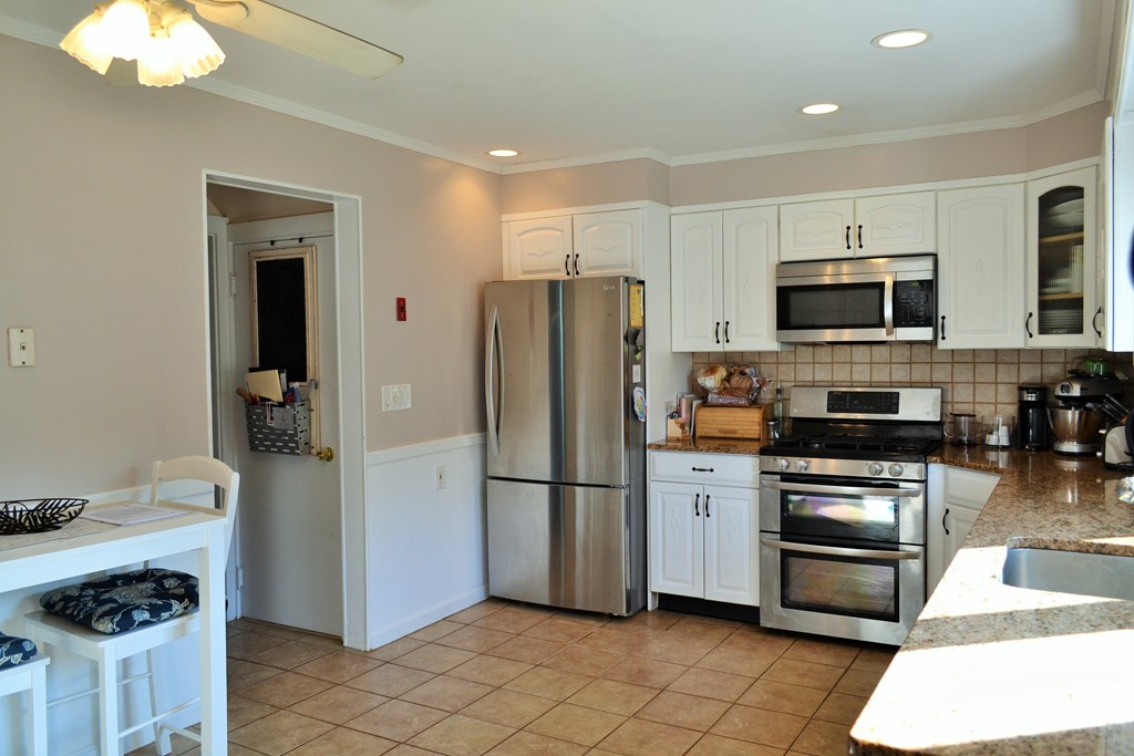 29 Station Road Salem, MA 01970 - Photo 10 of 24 a kitchen with stainless steel appliances granite countertop a refrigerator and a stove top oven