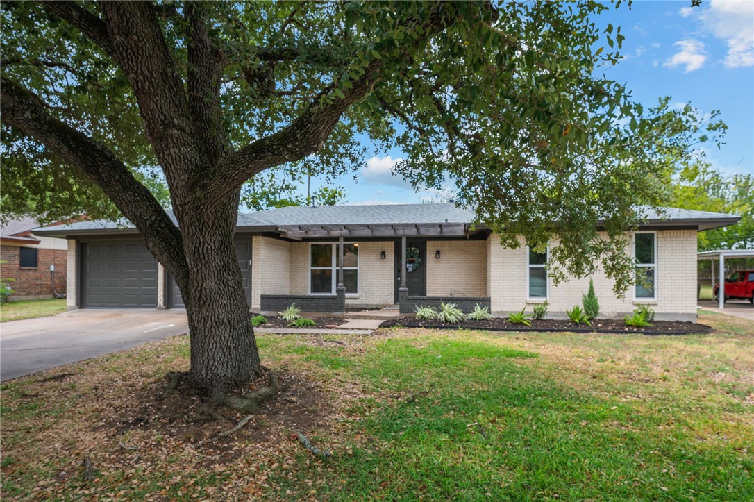 1509 Barak Lane Bryan, TX 77802 - Photo 1 of 1 a front view of a house with a yard and large trees