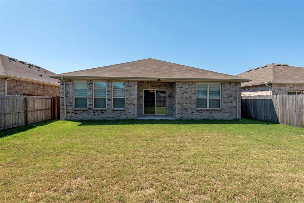 1005 Stanridge Lane Van Alstyne, TX 75495 - Photo 2 of 2 a view of a house with a garden and yard