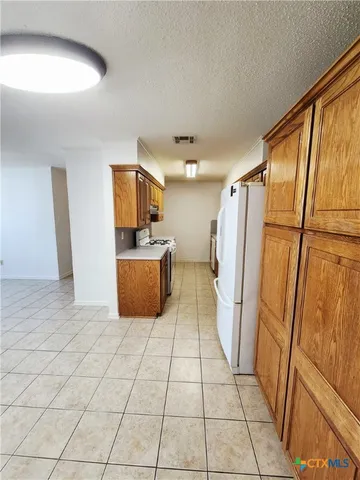a kitchen with a refrigerator and a sink