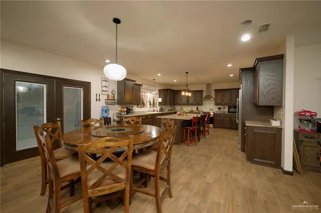 a kitchen with stainless steel appliances kitchen island granite top and refrigerator
