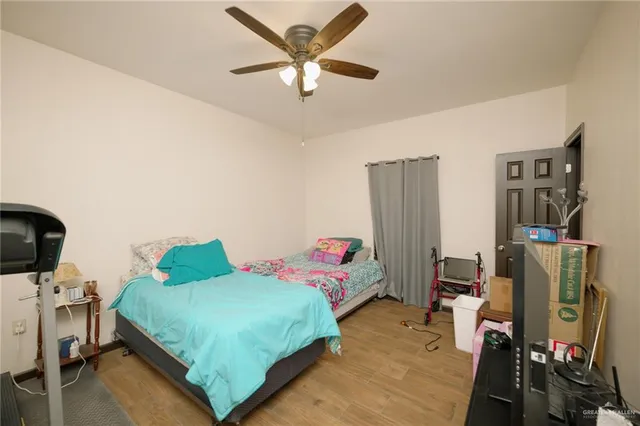 a bedroom with a bed and a flat tv screen on the dresser