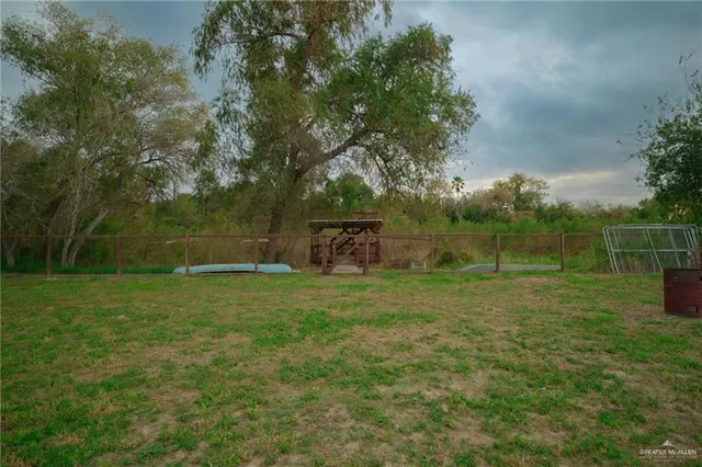 a view of a balcony with chairs and wooden fence