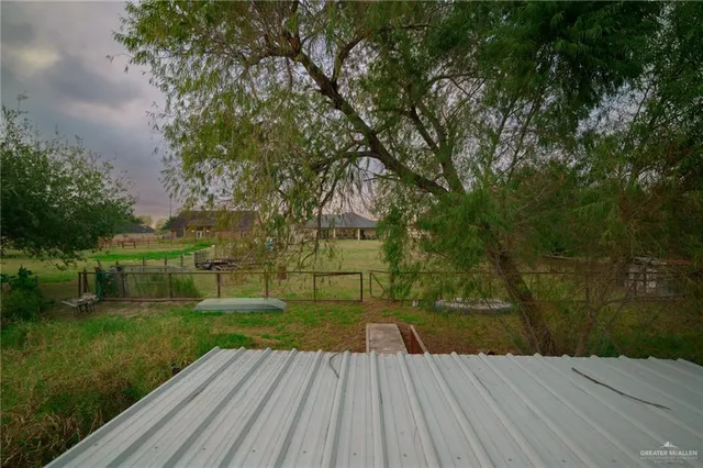 a view of a field with trees in the background
