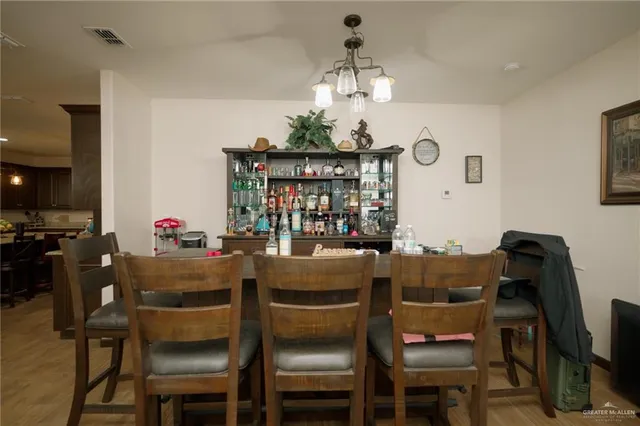 a dining room with furniture a chandelier and window