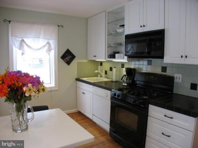 605 Deepdene Road Baltimore, MD 21210 - Photo 20 of 30 a kitchen with stainless steel appliances a sink dishwasher stove microwave and cabinets