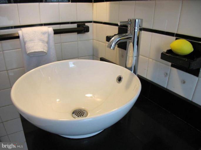 605 Deepdene Road Baltimore, MD 21210 - Photo 22 of 30 a bathroom with a sink and mirror