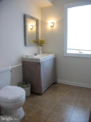 605 Deepdene Road Baltimore, MD 21210 - Photo 24 of 30 a bathroom with a toilet sink and mirror