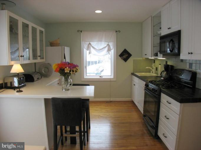 605 Deepdene Road Baltimore, MD 21210 - Photo 4 of 30 a kitchen with a sink cabinets and window