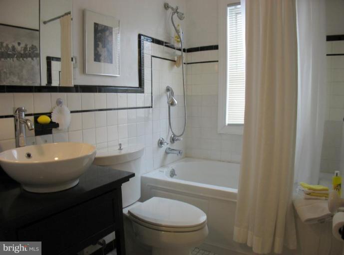 605 Deepdene Road Baltimore, MD 21210 - Photo 7 of 30 a bathroom with a sink a toilet and shower