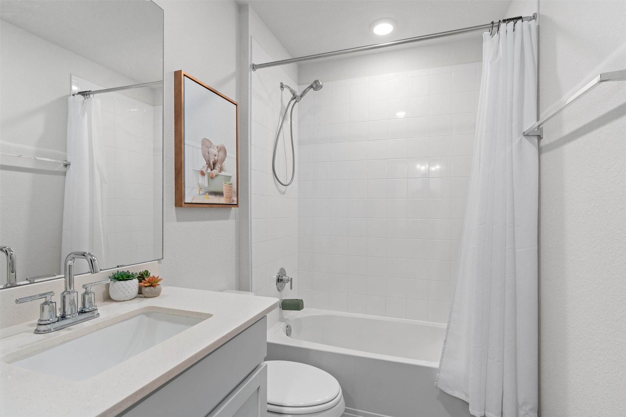 19912 Abigail Fillmore Road Manor, TX 78653 - Photo 16 of 31 A well-appointed bathroom with a sleek vanity, modern fixtures, and a clean tub-shower combination.