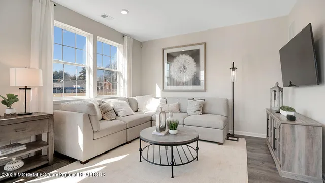 a living room with furniture a table and a large window
