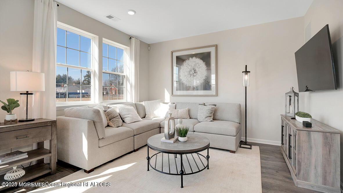 10 Mantoloking Drive Jackson, NJ 08527 - Photo 12 of 22 a living room with furniture a large window and a flat screen tv
