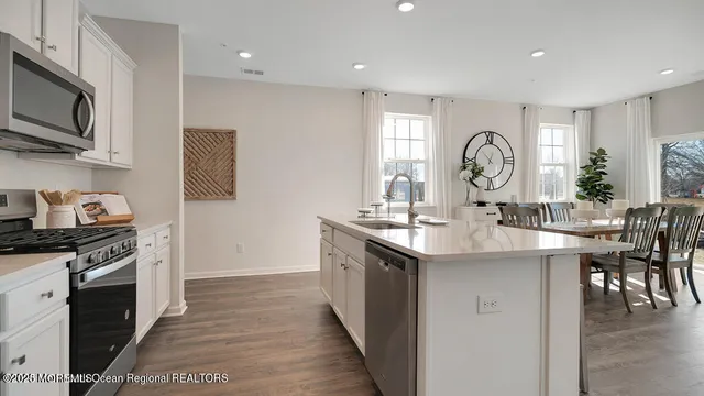 a kitchen with a sink microwave and stove