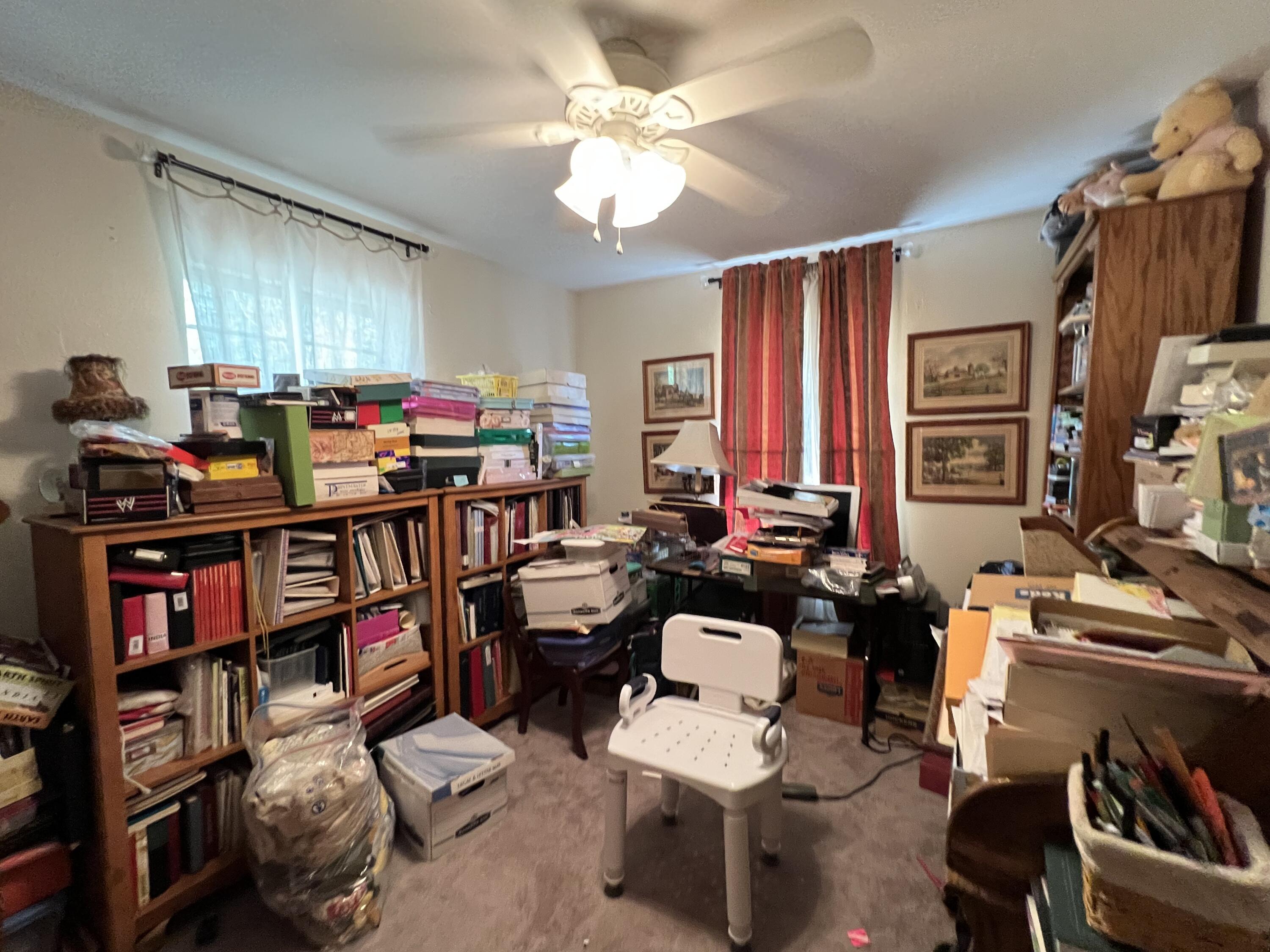 3211 Maple Street Crestview, FL 32539 - Photo 14 of 41 a view of a workspace with furniture and a livingroom