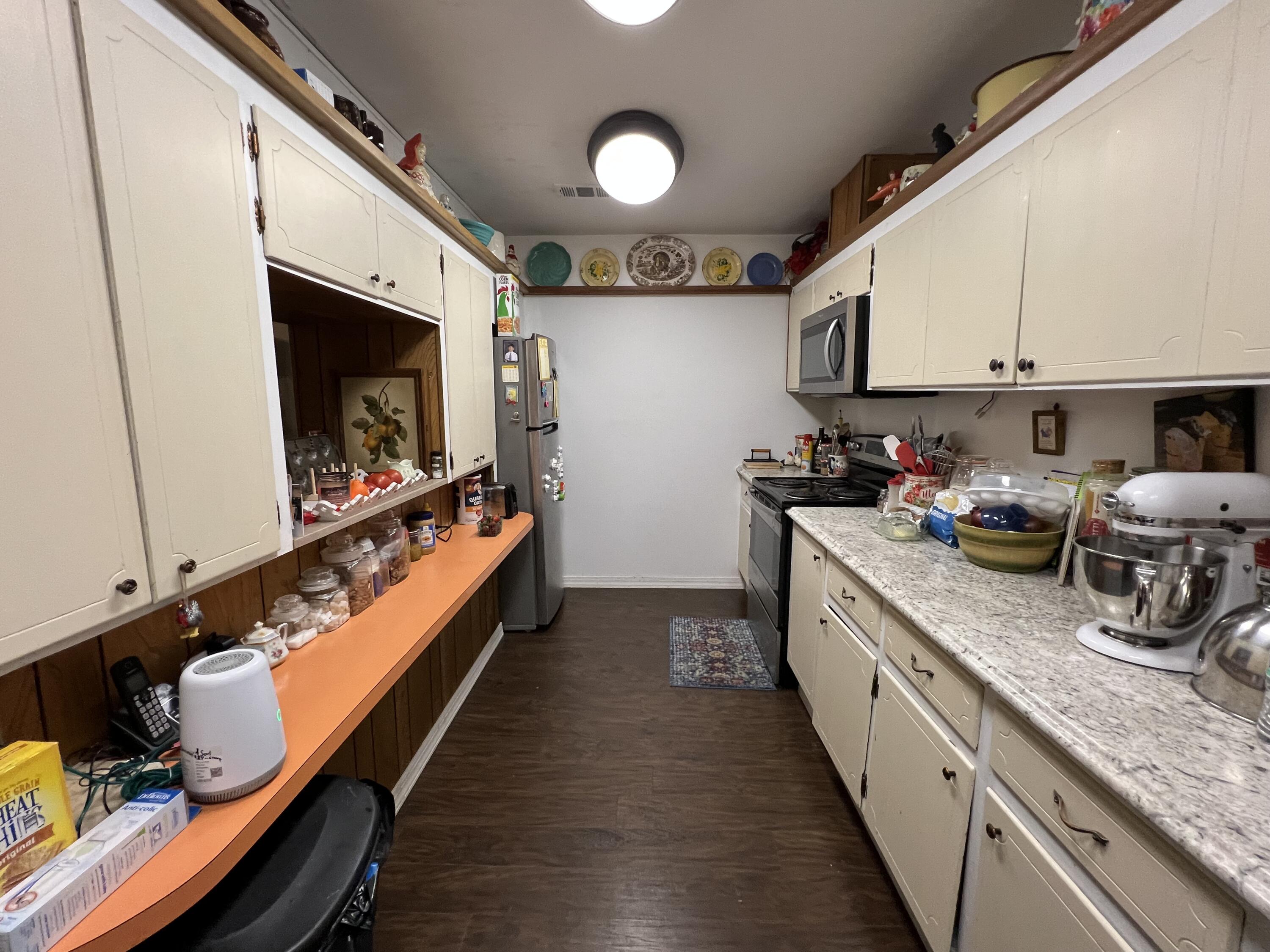 3211 Maple Street Crestview, FL 32539 - Photo 17 of 41 a kitchen with stainless steel appliances granite countertop a stove a sink and a microwave