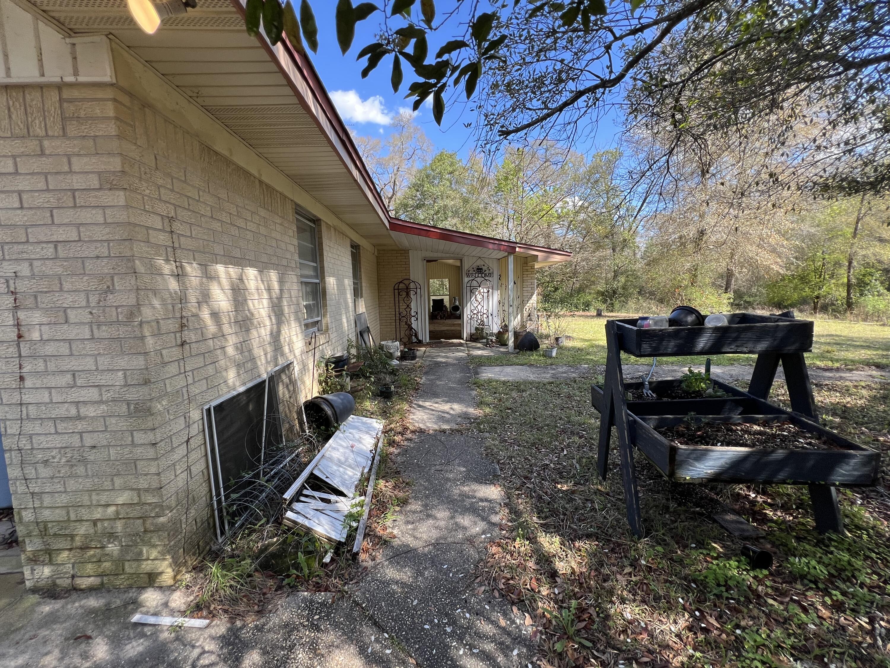 3211 Maple Street Crestview, FL 32539 - Photo 19 of 41 a view of a backyard with sitting area