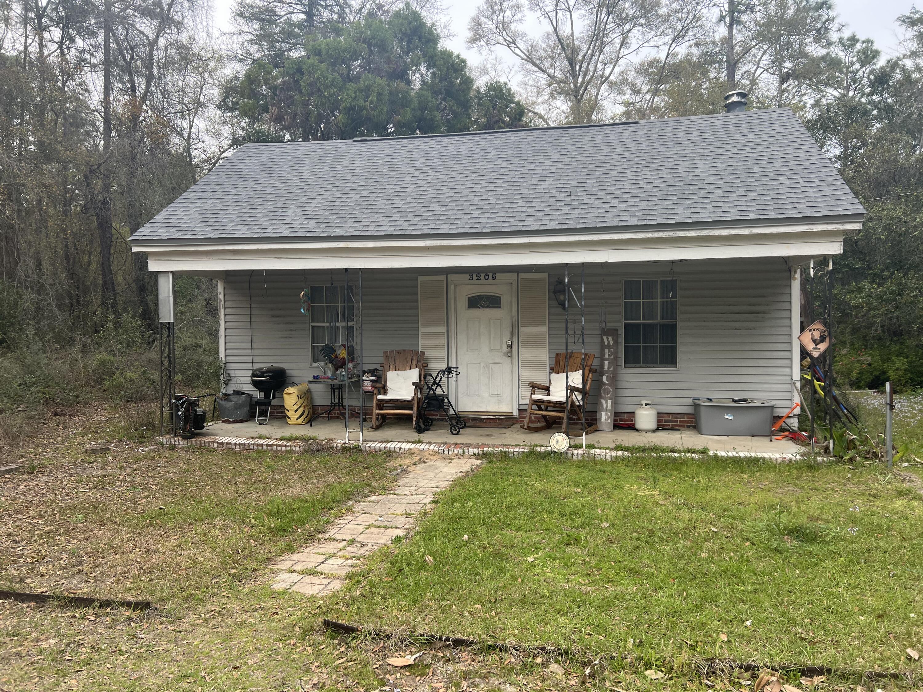 3211 Maple Street Crestview, FL 32539 - Photo 21 of 41 a view of a house with backyard porch and sitting area