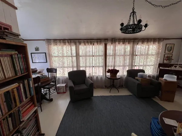 a living room with furniture fireplace and a window