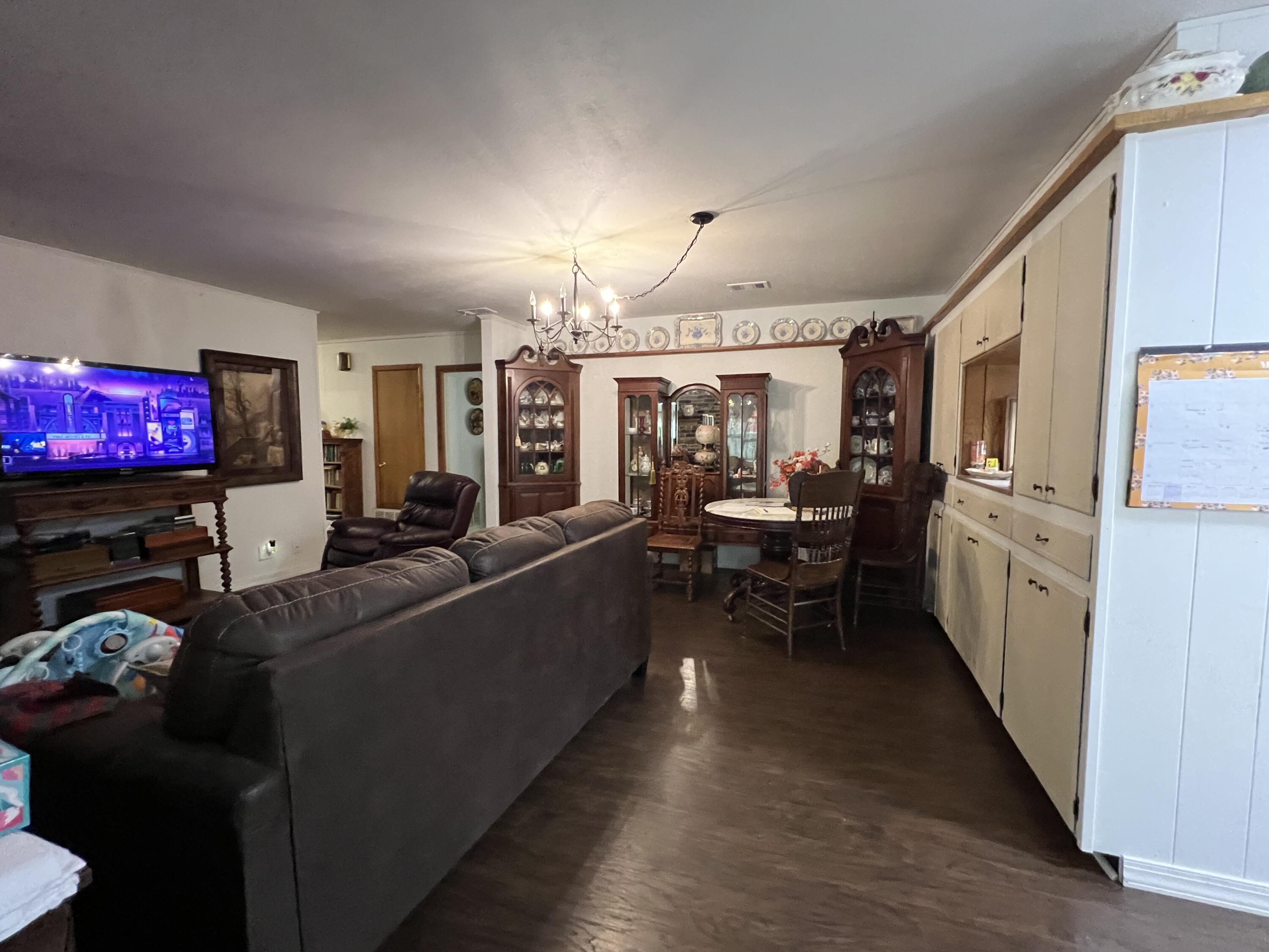 3211 Maple Street Crestview, FL 32539 - Photo 7 of 41 a living room with furniture and a flat screen tv