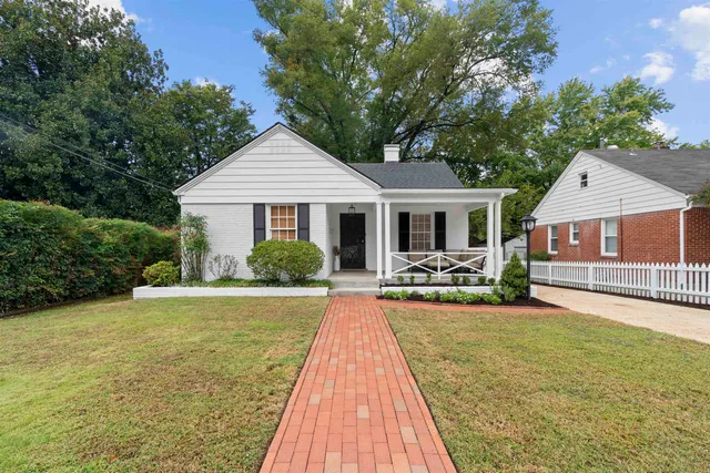 a front view of a house with yard patio and green space