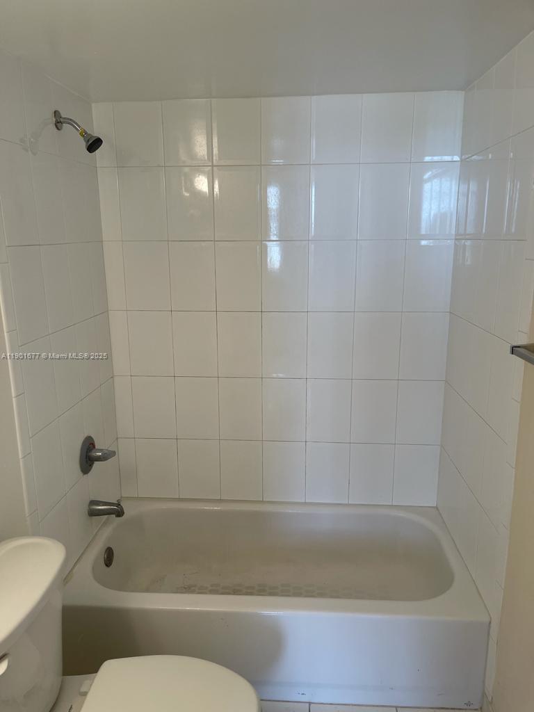 8251 Northwest 8th Street, Unit 414 Miami, FL 33126 - Photo 11 of 25 a bathroom with a bathtub and toilet